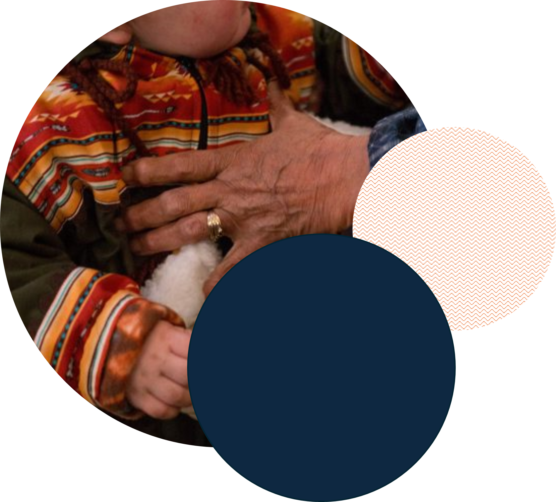 An Elder holds a child dressed in traditional clothing